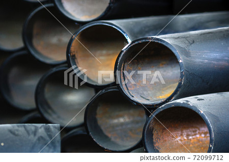 Black metal pipes and adapters of different diameters for gasification or water supply. Industrial background Black metal pipes and adapters of different diameters for gasification or water supply. Industrial background 72099712