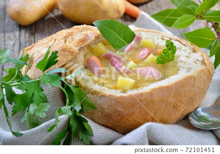 Freshly made potato soup in a loaf of bread with bacon strips and Vienna sausage wheels Freshly made potato soup in a loaf of bread with bacon strips and Vienna sausage wheels 72101451