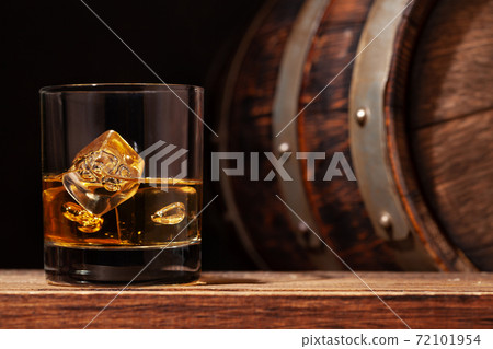 Scotch whiskey glass and old barrel Scotch whiskey glass and old barrel 72101954