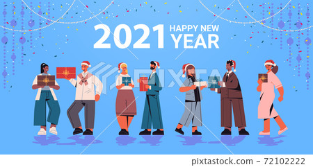 colleagues in santa hats holding gifts mix race office workers celebrating 2021 new year and christmas holidays 72102222