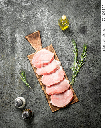 Raw pork steaks with herbs and spices. Raw pork steaks with herbs and spices. 72104105