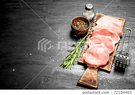 Raw pork steaks with spices and herbs. Raw pork steaks with spices and herbs. 72104403