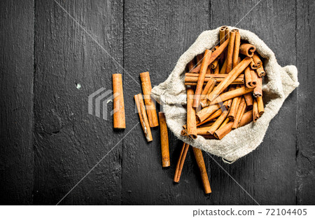 Cinnamon sticks in an old bag. Cinnamon sticks in an old bag. 72104405