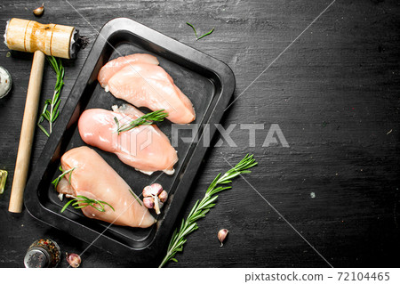 Raw chicken fillet with herbs and spices. Raw chicken fillet with herbs and spices. 72104465