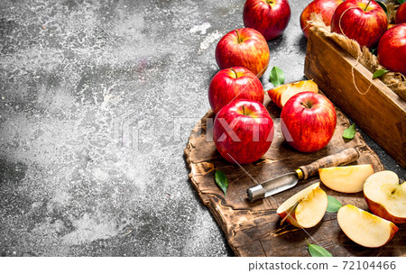 Red apples on a chopping Board with box. Red apples on a chopping Board with box. 72104466