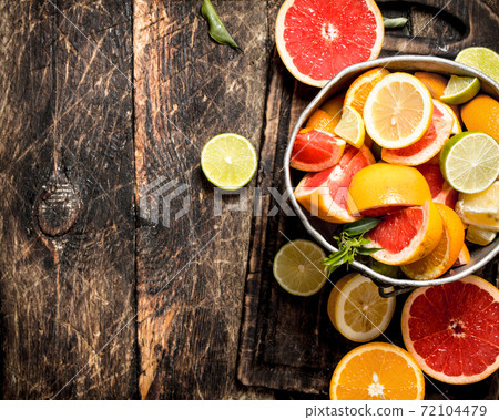 Citrus background. Fresh citrus fruits in the old bucket. Citrus background. Fresh citrus fruits in the old bucket. 72104479