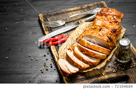 Sliced grilled meat on a Board with spices. 72104684