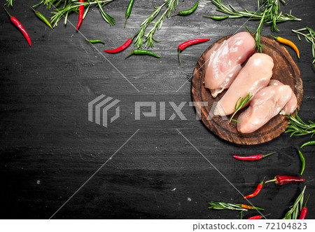 Raw chicken fillet with herbs and spices. Raw chicken fillet with herbs and spices. 72104823
