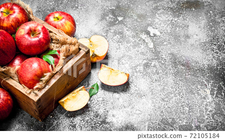 Red apples in an old box. 72105184