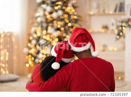 Young happy couple embracing and relaxing on comfortable couch 72105397