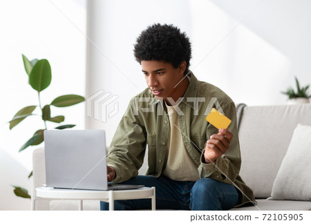 Young black guy using credit card for online... - Stock Photo [72105905 ...