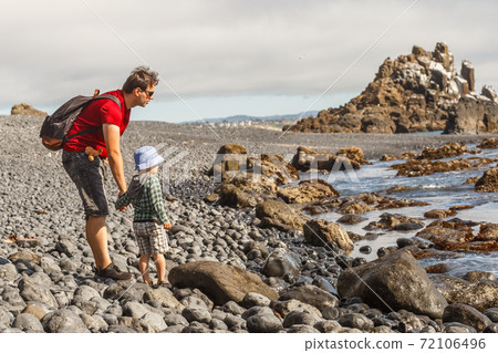 Dad and son on Cobble Beach near Yaquina Head 72106496