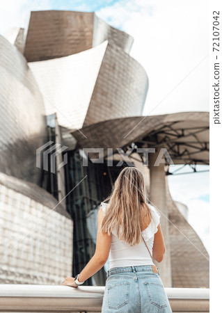 Woman visiting the Guggenheim museum in Bilbao Woman visiting the Guggenheim museum in Bilbao 72107042