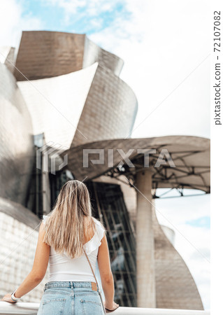 Woman visiting the Guggenheim museum in Bilbao Woman visiting the Guggenheim museum in Bilbao 72107082