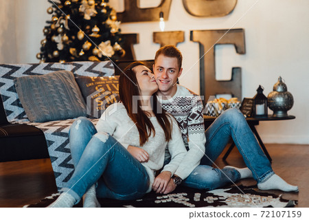a guy and a girl celebrate the new year together. and give each other gifts a guy and a girl celebrate the new year together. and give each other gifts 72107159