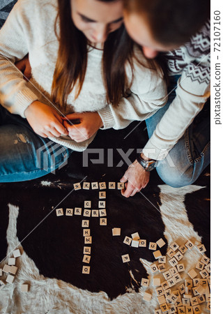 a guy and a girl celebrate the new year together. and give each other gifts a guy and a girl celebrate the new year together. and give each other gifts 72107160