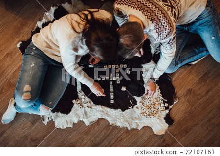a guy and a girl celebrate the new year together. and give each other gifts 72107161