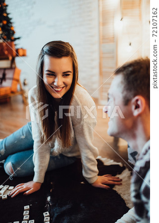 a guy and a girl celebrate the new year together. and give each other gifts a guy and a girl celebrate the new year together. and give each other gifts 72107162