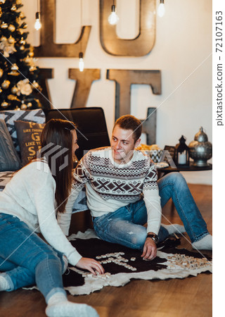 a guy and a girl celebrate the new year together. and give each other gifts a guy and a girl celebrate the new year together. and give each other gifts 72107163