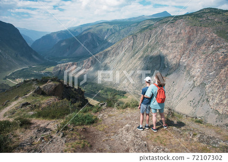 Woman an her son on the viewpoint of valley of the river of Chulyshman 72107302