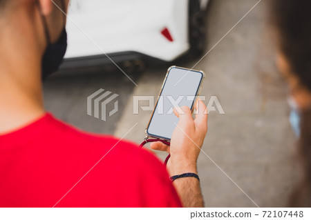Mockup of a man using his smartphone 72107448