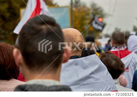 Peaceful demonstration when participants walk along the road Peaceful demonstration when participants walk along the road 72108325