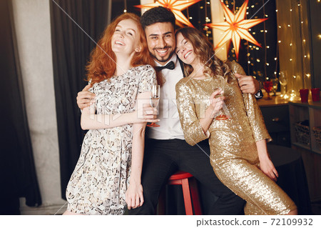 International people having fun in a decorated room International people having fun in a decorated room 72109932