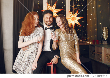 International people having fun in a decorated room International people having fun in a decorated room 72109933
