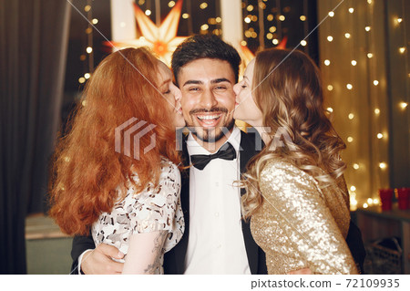 International people having fun in a decorated room International people having fun in a decorated room 72109935