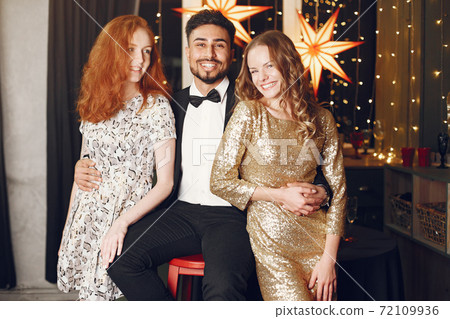 International people having fun in a decorated room International people having fun in a decorated room 72109936