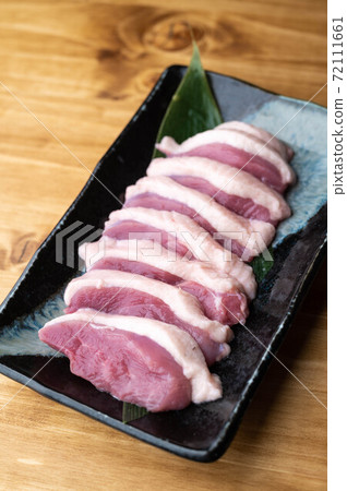 sliced raw duck meat on japanese dish 72111661