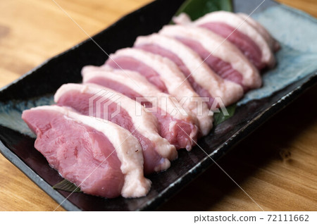 sliced raw duck meat on japanese dish 72111662