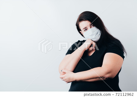 Bored sad young woman wearing medical mask Bored sad young woman wearing medical mask 72112962