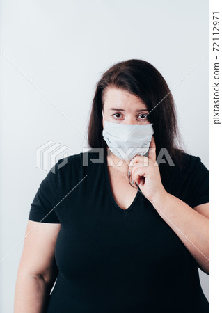 Bored woman in medical mask and gloves Bored woman in medical mask and gloves 72112971
