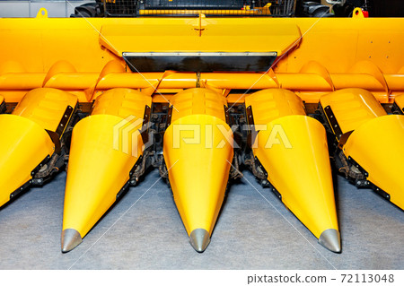 Close-up of the front of a corn harvester. 72113048