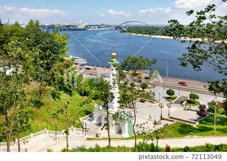 Beautiful landscape of summer Kyiv with a view of the Dnipro River and a monument to the Magdeburg Law. Beautiful landscape of summer Kyiv with a view of the Dnipro River and a monument to the Magdeburg Law. 72113049