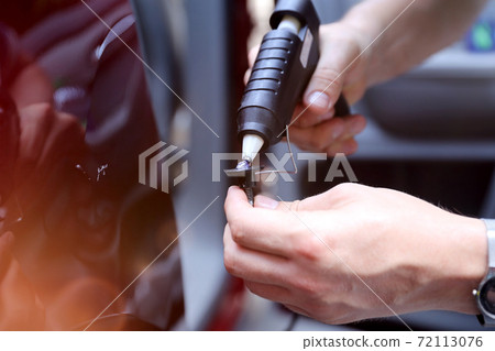 Man fixing car dent by himself 72113076