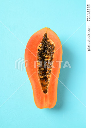 Half ripe papaya fruit on color background, Tropical fruit 72118265