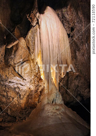 Cave with stalactites and stalagmites. Geological formation karst 72118590