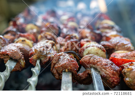 Skewers uncooked in nature on skewers in the open air. Skewers uncooked in nature on skewers in the open air. 72118681