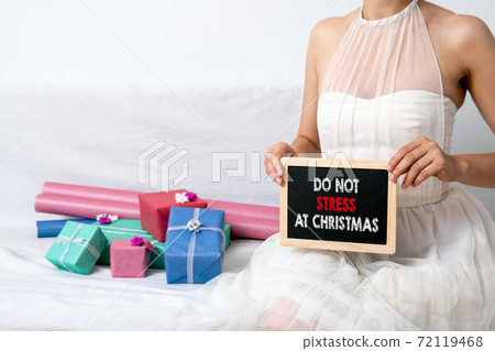 DO NOT STRESS AT CHRISTMAS. Women in ball dress. Gift boxes in colorful wrapping pape DO NOT STRESS AT CHRISTMAS. Women in ball dress. Gift boxes in colorful wrapping pape 72119468