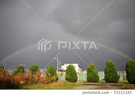 Cloudy sky in late autumn Two rainbows in a light rain Cloudy sky in late autumn Two rainbows in a light rain 72121183
