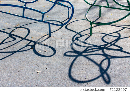Shadow of playground equipment in the park Shadow of playground equipment in the park 72122497