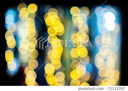 yellow blurry Christmas lights on the streets. holiday night background with bokeh effect. 72123767