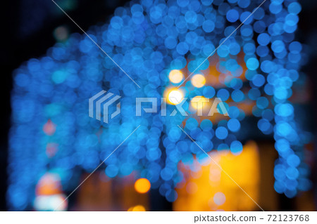 blue blurry Christmas lights on the streets. holiday night background with bokeh effect. blue blurry Christmas lights on the streets. holiday night background with bokeh effect. 72123768