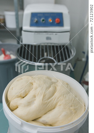 Fresh dough ready for baking in plastic basket. Preparation of bakery products Fresh dough ready for baking in plastic basket. Preparation of bakery products 72123902