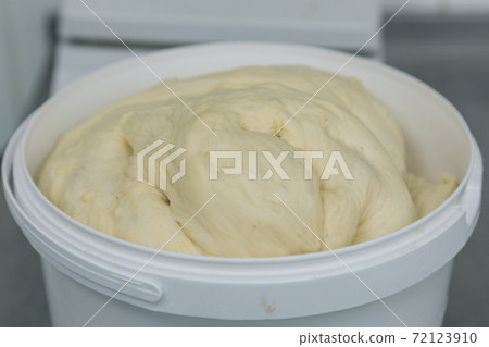 Fresh dough ready for baking in plastic basket. Preparation of bakery products Fresh dough ready for baking in plastic basket. Preparation of bakery products 72123910