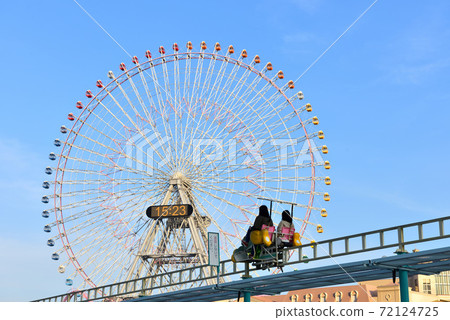 A two-seater attraction that goes on while looking at the Ferris wheel 72124725