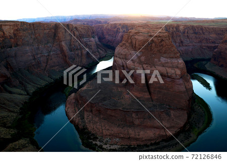 Sunset over famous Horseshoe Bend Utah and Arizona. The beautiful Colorado river carved this horseshoe shaped sandstone reflecting orange, red 72126846