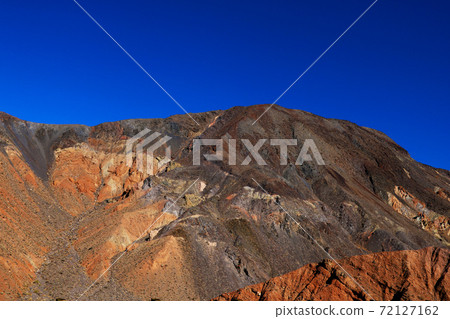 Moon Over Zabriskie Point Mudstones form Badlands Death Valley National Park California. Moon Over Zabriskie Point Mudstones form Badlands Death Valley National Park California. 72127162